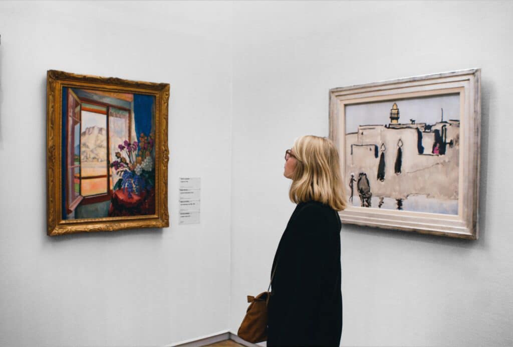 woman looking at art in a  gallery